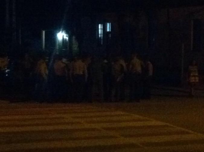 After the waiter's warnings, the sight of these 30 police officers standing stoic on a street corner in the middle of the night was made all the more eerie.